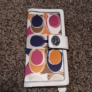 A Coach credit card and cash carrier